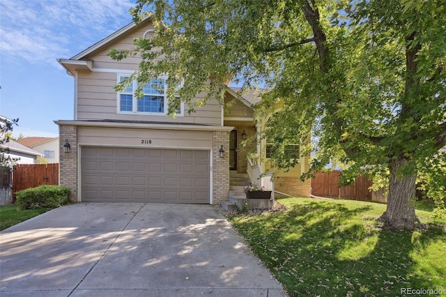 view of front of house featuring a front yard and a garage