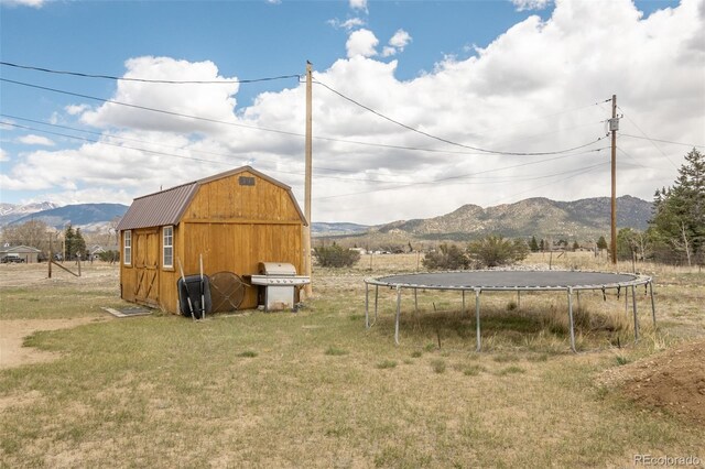 15980 County Road 306, Buena Vista, CO 81211 - view of barn with a lawn, a mountain view, and a trampoline
