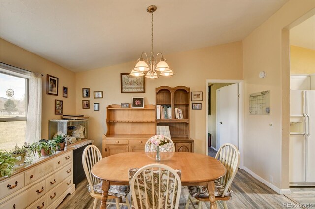15980 County Road 306, Buena Vista, CO 81211 - dining space with an inviting chandelier, baseboards, light wood-type flooring, and lofted ceiling
