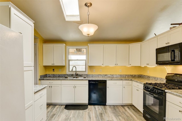 15980 County Road 306, Buena Vista, CO 81211 - kitchen with a sink, white cabinetry, light wood-type flooring, a skylight, and black appliances