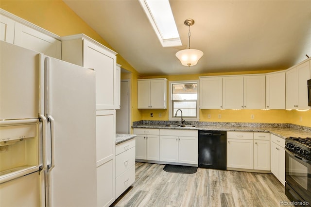15980 County Road 306, Buena Vista, CO 81211 - kitchen featuring vaulted ceiling with skylight, white cabinets, black appliances, and a sink