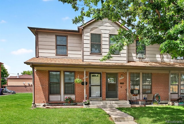 3947 W Ohio Ave, Denver, CO 80219 - traditional-style house with a porch, a front lawn, and brick siding
