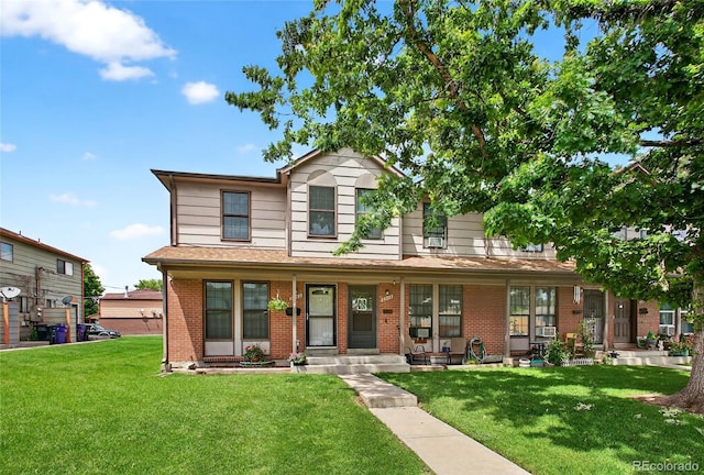 3947 W Ohio Ave, Denver, CO 80219 - traditional-style home featuring brick siding, a porch, and a front yard