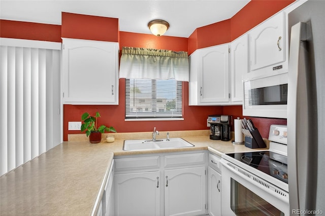 3947 W Ohio Ave, Denver, CO 80219 - kitchen featuring white appliances, white cabinetry, and light countertops