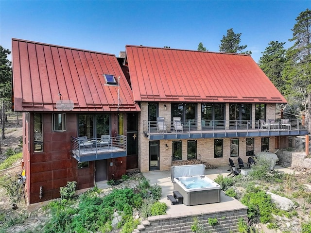 back of property featuring a balcony and a patio area