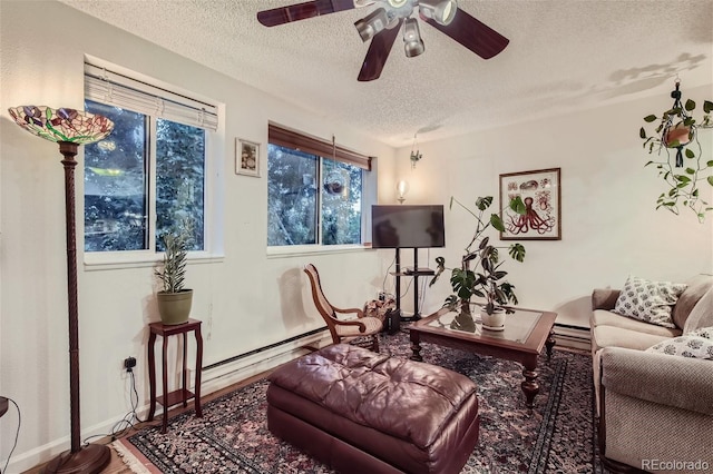 living room with a textured ceiling, hardwood / wood-style floors, and ceiling fan