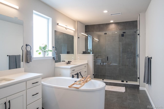 695 Simmental Loop, Castle Rock, CO 80104 - full bathroom featuring a shower stall, two vanities, a freestanding tub, and recessed lighting