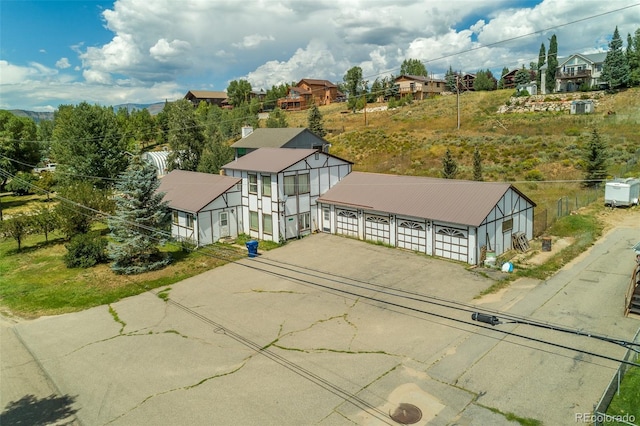 view of front of home with a residential view and driveway