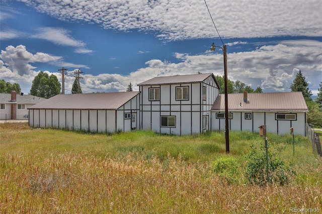 view of side of property featuring metal roof