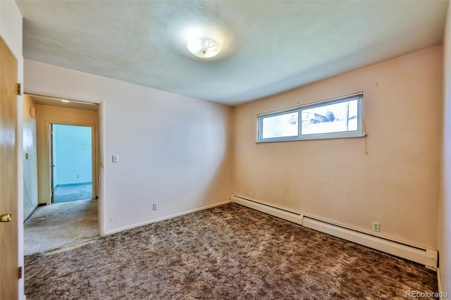 empty room featuring a textured ceiling, baseboard heating, and carpet flooring