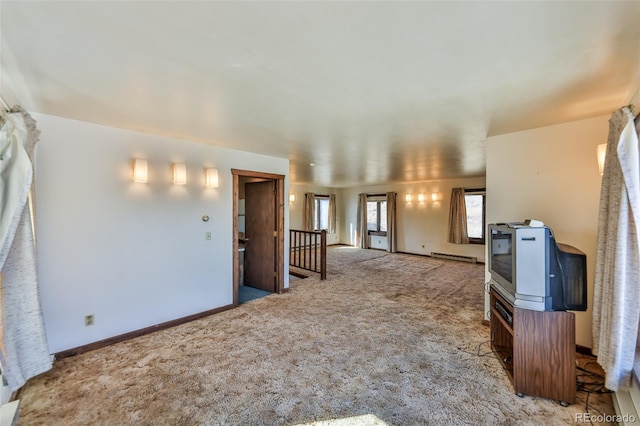 unfurnished living room with baseboards, light colored carpet, and baseboard heating