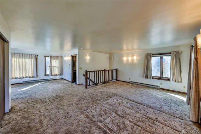 unfurnished living room with a baseboard radiator and carpet flooring