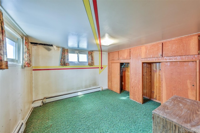 unfurnished bedroom featuring multiple windows, dark colored carpet, and a baseboard heating unit