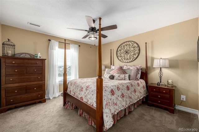 bedroom featuring carpet floors, ceiling fan, visible vents, and baseboards