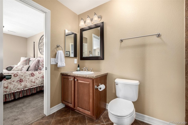 ensuite bathroom with visible vents, vanity, ensuite bath, tile patterned flooring, and baseboards