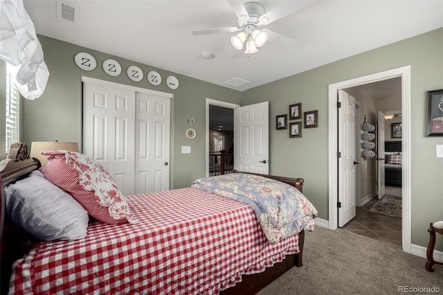 carpeted bedroom featuring ceiling fan, a closet, visible vents, and baseboards