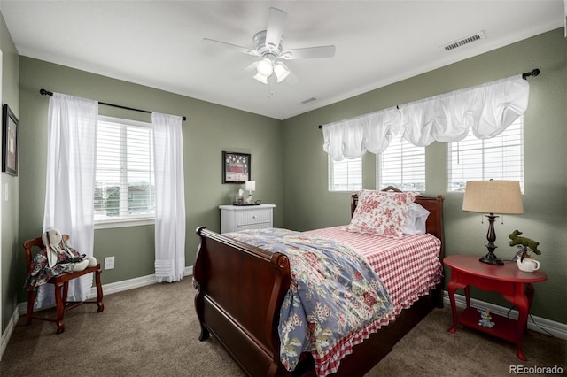 carpeted bedroom featuring ceiling fan, visible vents, and baseboards