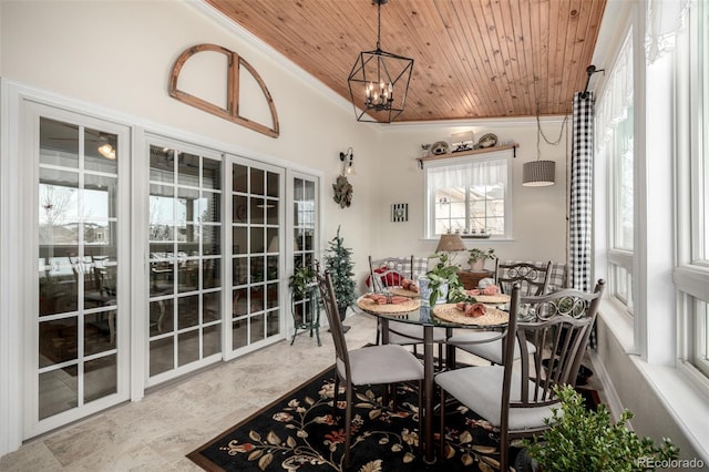 dining area with wood ceiling, crown molding, and an inviting chandelier