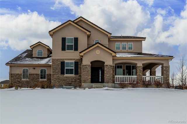 view of front of house with covered porch, stone siding, and stucco siding