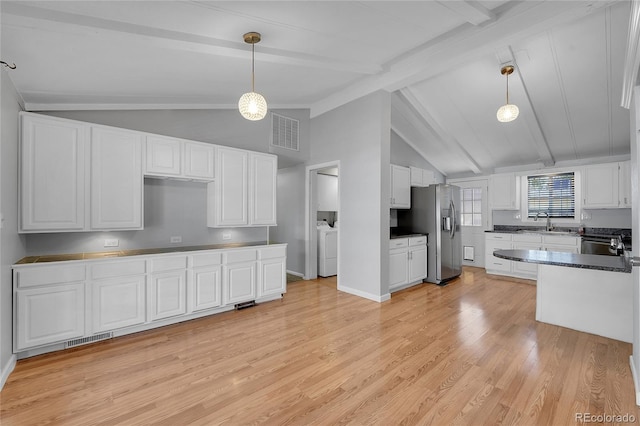 kitchen featuring lofted ceiling with beams, white cabinetry, and decorative light fixtures