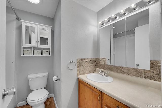 bathroom with vanity, toilet, and wood-type flooring