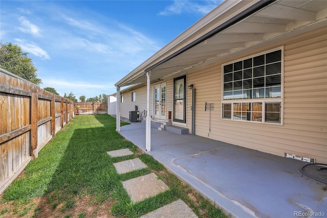 view of yard featuring a patio and central air condition unit