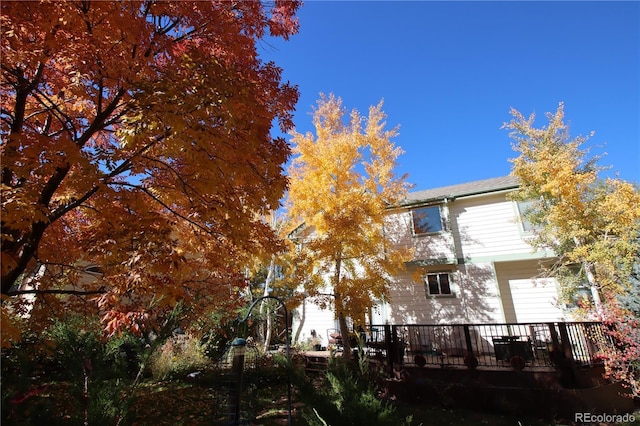 back of property featuring a wooden deck