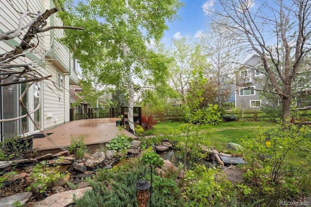 248 Summit Trl, Broomfield, CO 80020 - view of yard with a small pond, a deck, and a fenced backyard