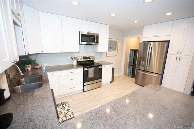3111 W Bails Pl, Denver, CO 80219 - kitchen with stainless steel appliances, decorative backsplash, white cabinetry, stone countertops, and recessed lighting