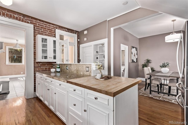 368 S Humboldt St, Denver, CO 80209 - kitchen featuring butcher block countertops, freestanding refrigerator, glass insert cabinets, white cabinetry, and dark wood-style floors