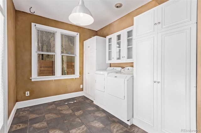 368 S Humboldt St, Denver, CO 80209 - laundry area featuring cabinet space, baseboards, washing machine and dryer, and stone finish flooring