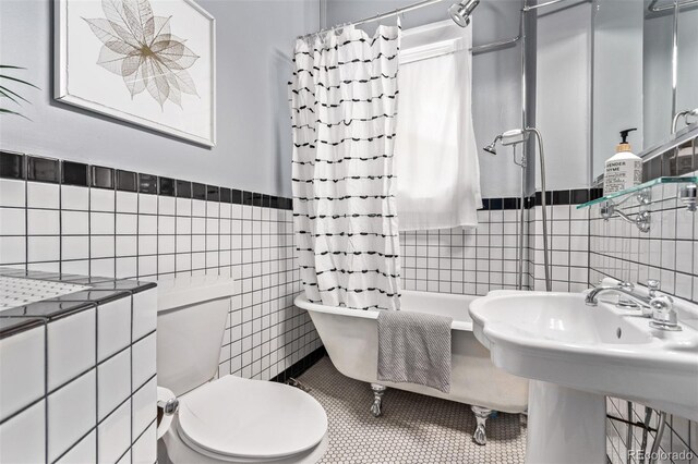 368 S Humboldt St, Denver, CO 80209 - full bathroom featuring tile walls, toilet, tile patterned flooring, shower / bath combination with curtain, and a wainscoted wall