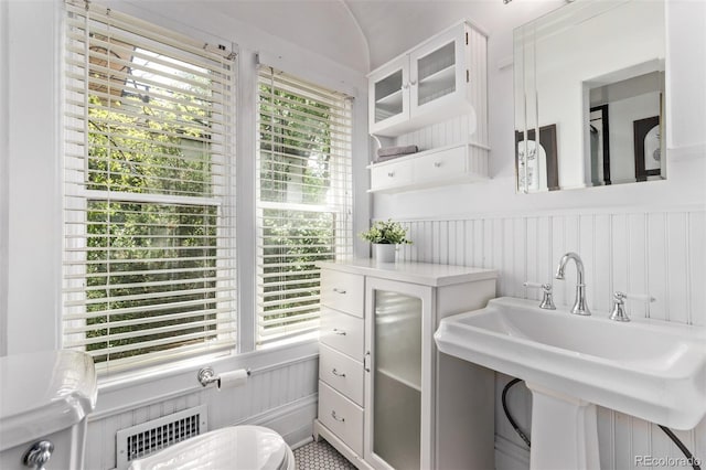 368 S Humboldt St, Denver, CO 80209 - bathroom with a sink, a wainscoted wall, a decorative wall, and radiator