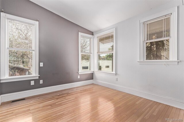 368 S Humboldt St, Denver, CO 80209 - empty room featuring healthy amount of natural light, wood finished floors, vaulted ceiling, and baseboards