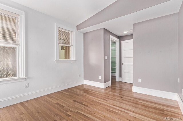 368 S Humboldt St, Denver, CO 80209 - empty room featuring wood finished floors, baseboards, plenty of natural light, and vaulted ceiling