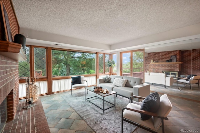 sunroom / solarium featuring a brick fireplace