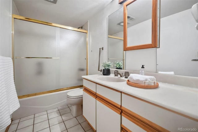 bathroom featuring visible vents, bath / shower combo with glass door, toilet, tile patterned floors, and vanity