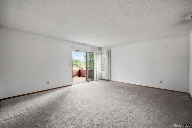 unfurnished room with baseboards, carpet, and a textured ceiling