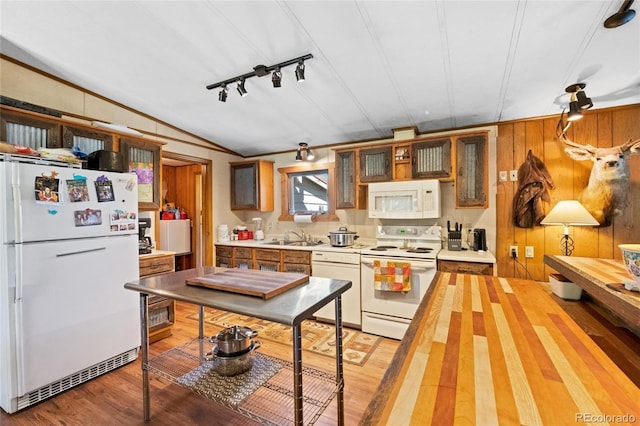 kitchen featuring white appliances, rail lighting, sink, ornamental molding, and light hardwood / wood-style floors