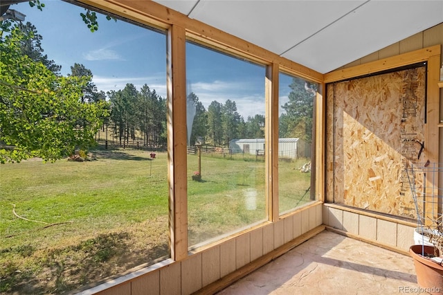 10000 State Highway 96, Westcliffe, CO 81252 - unfurnished sunroom with lofted ceiling, view of wooded area, and plenty of natural light