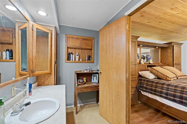 bathroom featuring vanity and vaulted ceiling