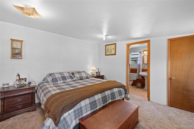 carpeted bedroom with ensuite bathroom