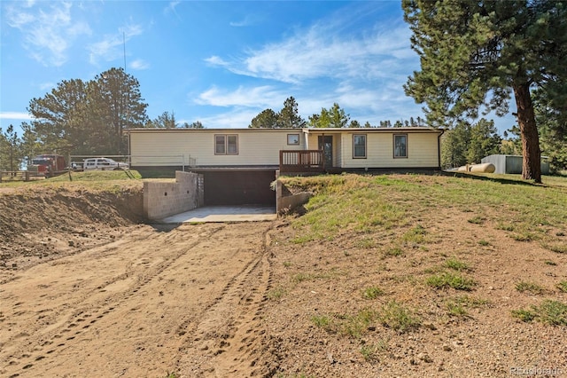 view of front of house with a garage and a deck