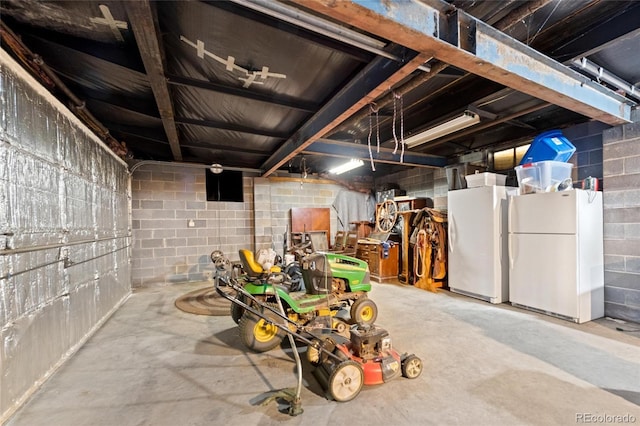 10000 State Highway 96, Westcliffe, CO 81252 - basement with freestanding refrigerator, concrete block wall, and a garage