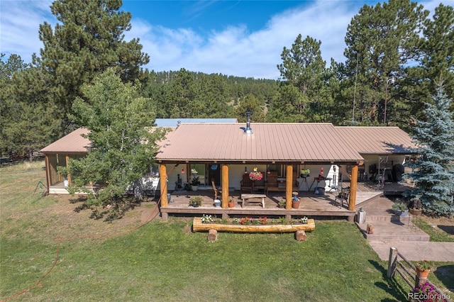 10000 State Highway 96, Westcliffe, CO 81252 - back of house with a metal roof, a lawn, and a view of trees