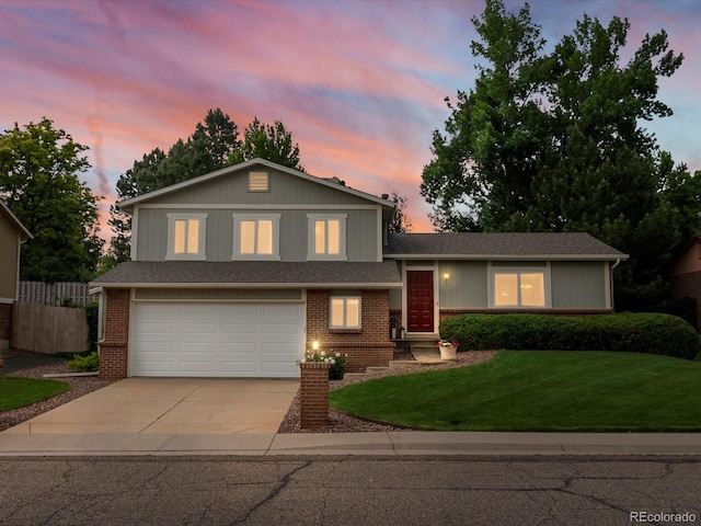 13762 W 67th Pl, Arvada, CO 80004 - tri-level home with driveway, an attached garage, and brick siding