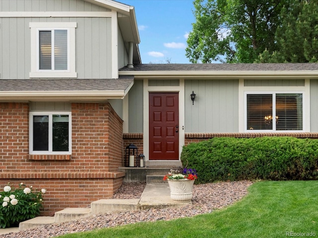 13762 W 67th Pl, Arvada, CO 80004 - doorway to property with brick siding and a shingled roof