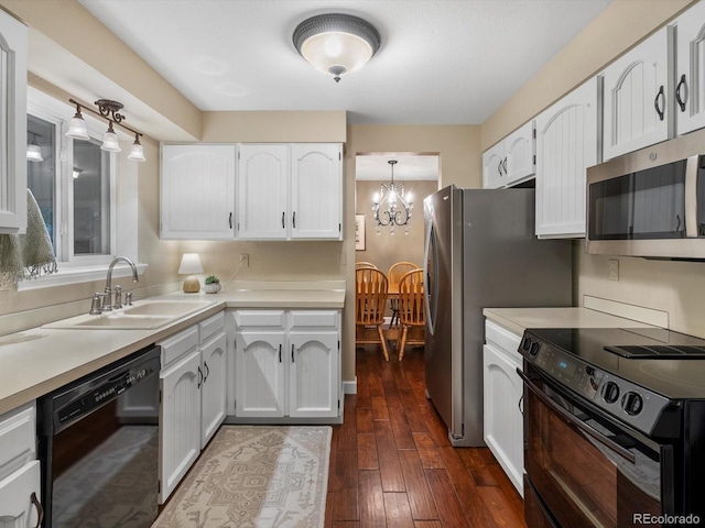 13762 W 67th Pl, Arvada, CO 80004 - kitchen with black appliances, white cabinets, a chandelier, and dark wood-style flooring