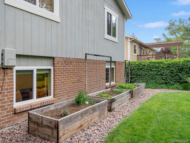 13762 W 67th Pl, Arvada, CO 80004 - view of home's exterior featuring a vegetable garden, brick siding, and a yard