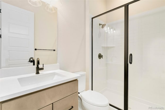 bathroom with vanity, toilet, and walk in shower